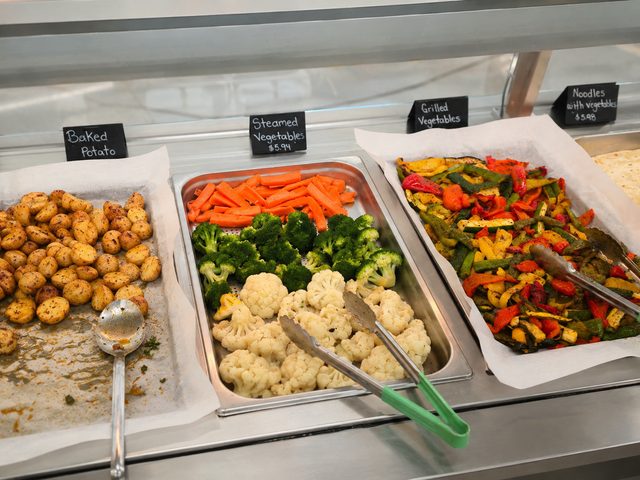 Steamed vegetables and sides on the hot line